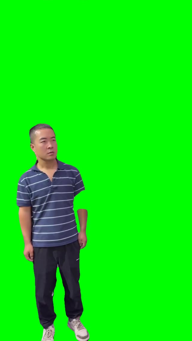 Asian guy stating down green screen