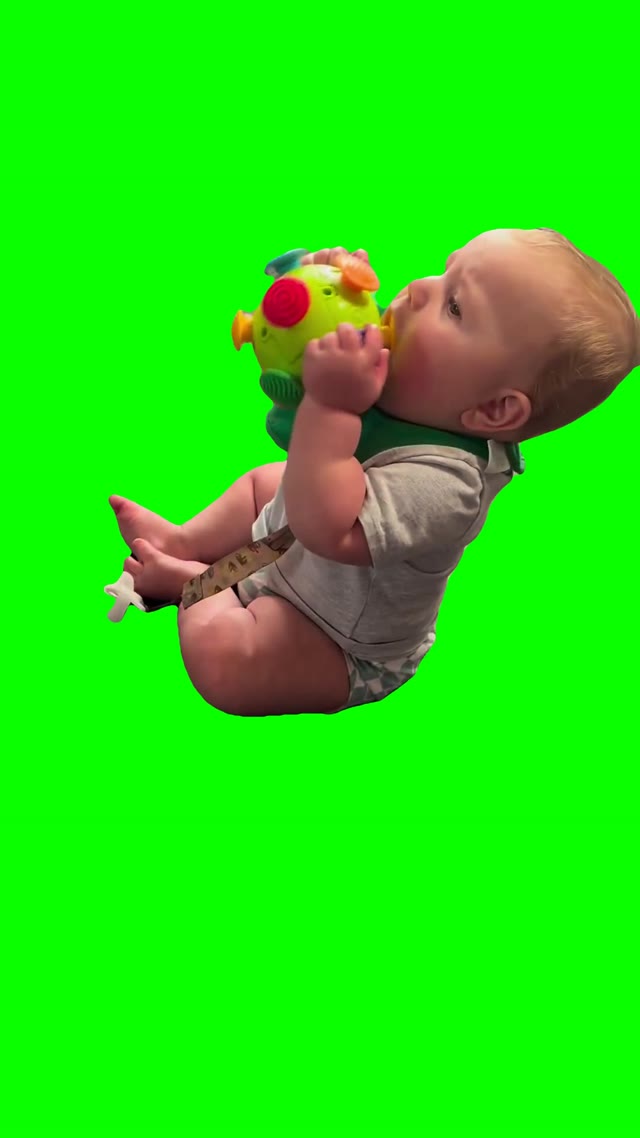 Baby playing with shaking toy green screen