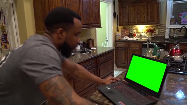 Cash Nasty punches a laptop green screen