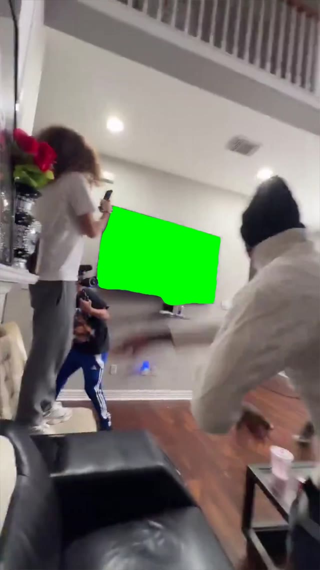 Guy theows rock at the tv and breaks tv green screen