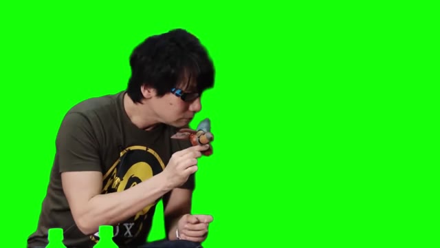 Hideo Kojima sniffing Metal Gear RAY green screen