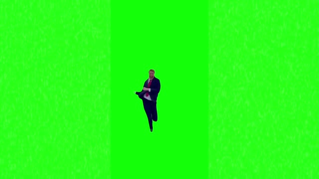 Man in suit dancing green screen