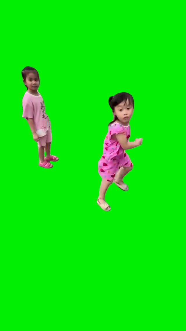 Two girls kicking green screen